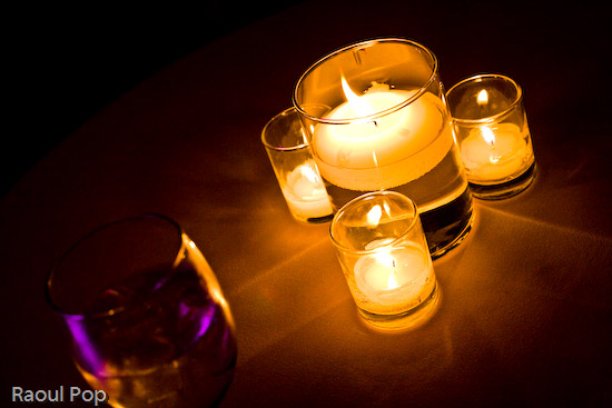 A glass of tonic water by candlelight