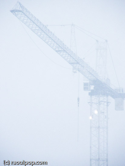 Tall crane during snowstorm